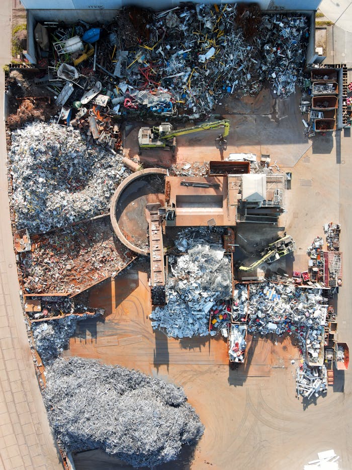 Aerial photo capturing a recycling facility in Regensburg, showcasing scrap and machinery.