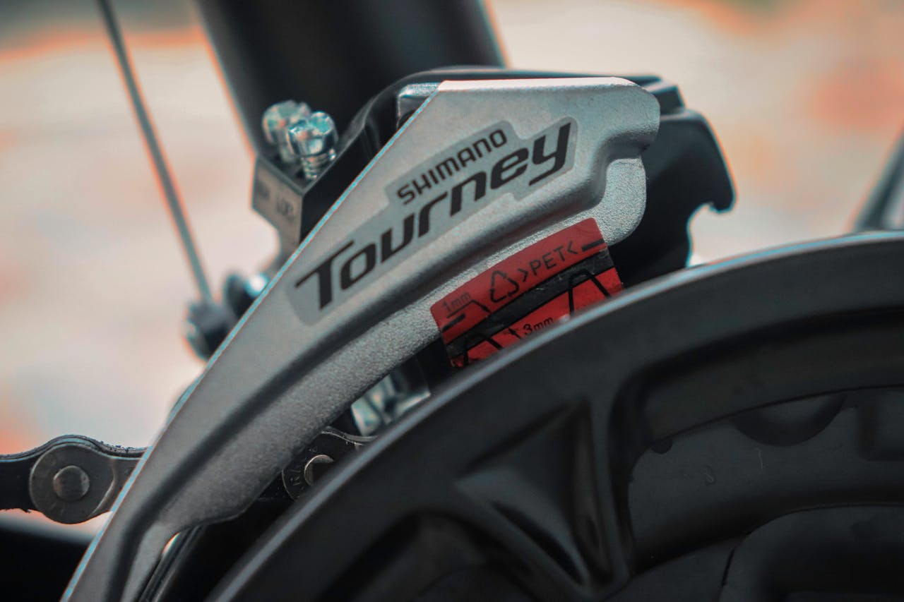 Home Detailed view of Shimano Tourney gear on a bicycle, highlighting mechanical precision and design.